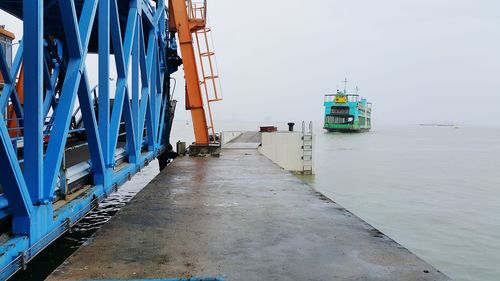 Ship moored at harbor against clear sky