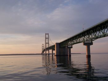 View of bridge over sea against cloudy sky