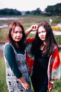 Portrait of friends standing outdoors