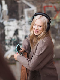 Happy woman listening music on headphones
