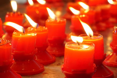 Close-up of lit tea light candles in temple