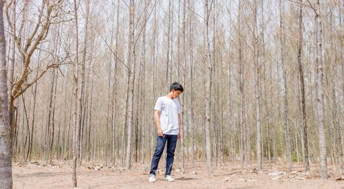 Full length of man standing in forest