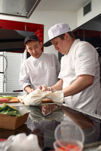 Side view of man preparing food at home