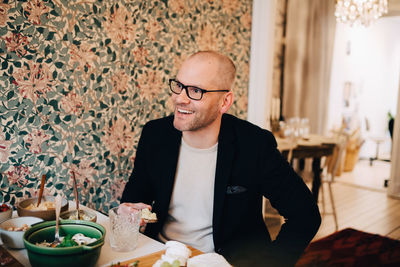 Mid section of man sitting on table