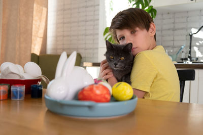 Boy painting easter eggs. concept of kid creativity, diy, handmade. paints eggs for easter holiday. 