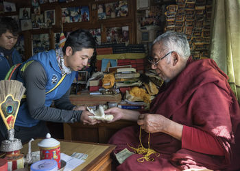 Nepal, sherpa getting a blessing from moch, before climbing he mount everest