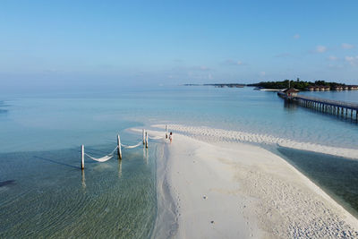 Lonely woman walking on a beach of maldive islands