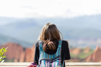 Rear view of woman looking at camera