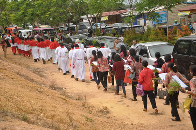 People attending religious mass while walking on field