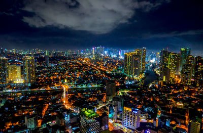 High angle view of illuminated buildings against sky at night