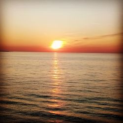 Scenic view of sea against romantic sky at sunset