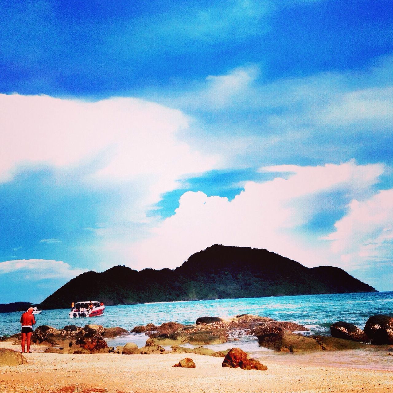 water, beach, sky, sea, scenics, shore, mountain, tranquil scene, tranquility, beauty in nature, sand, cloud - sky, nature, blue, cloud, vacations, mountain range, idyllic, incidental people, coastline