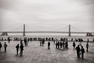 Bridge over river with city in background