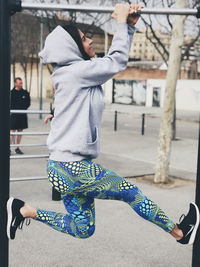 Midsection of woman walking on street in city