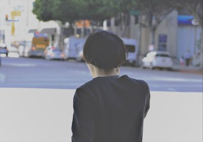 Rear view of a man standing in city