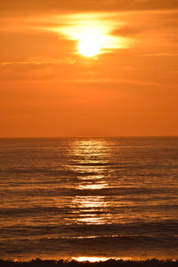 Scenic view of sea against romantic sky at sunset