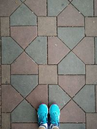 Low section of person standing on tiled floor