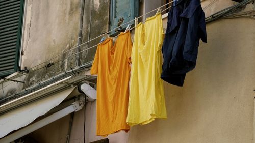 Low angle view of clothes drying against building