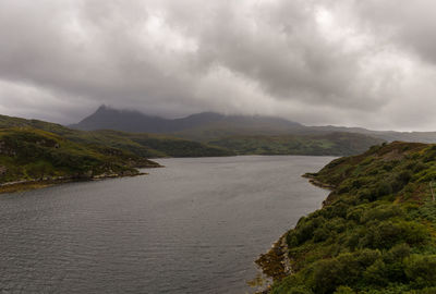 Scenic view of sea and mountains against sky