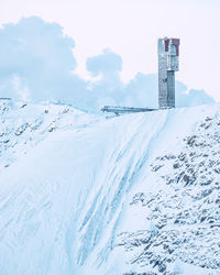 Snow covered buildings against sky