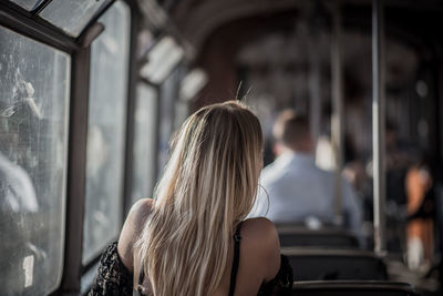 Rear view of woman traveling in bus