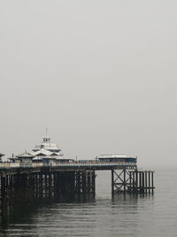 Pier over sea against clear sky