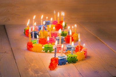 High angle view of illuminated candles on table