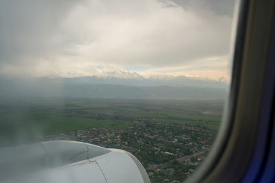 Aerial view of landscape seen through airplane window