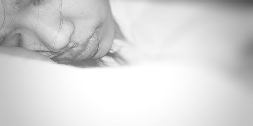 Close-up of young woman sleeping on bed