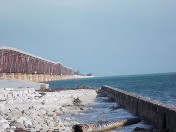 Scenic view of bridge over bay against sky