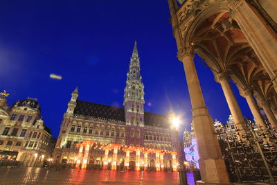 Low angle view of illuminated building against sky at night