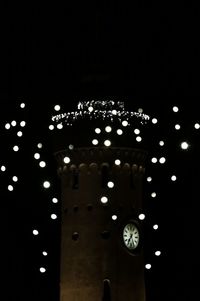 Low angle view of illuminated lights at night