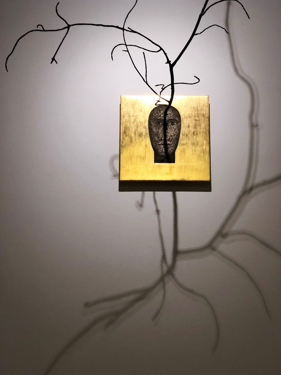 hanging, no people, wall - building feature, indoors, decoration, lighting equipment, close-up, home interior, still life, art and craft, representation, creativity, paper, animal representation, yellow, communication, tree, wall, branch, electric lamp