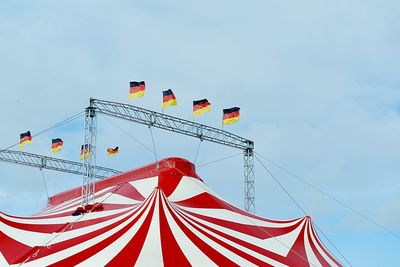 Low angle view of flags against sky