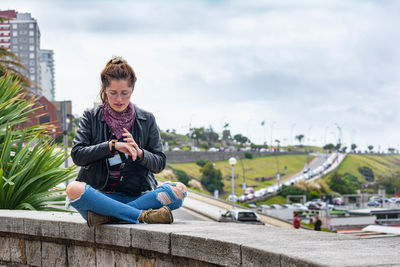 Portrait of young woman using mobile phone