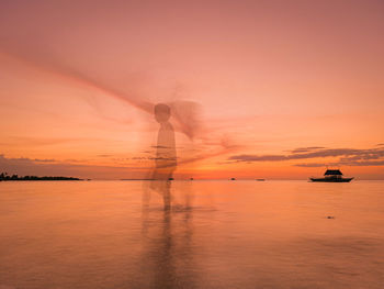 Scenic view of sea against orange sky