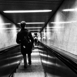 Man standing on escalator