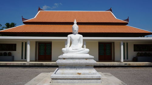 Statue of temple against building