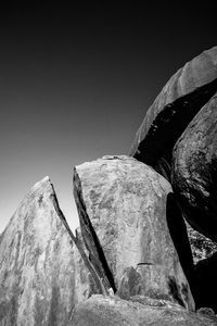 Low angle view of rock formation against clear sky