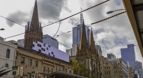 Low angle view of buildings against sky in city