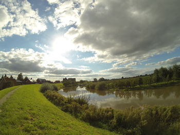 Scenic view of landscape against cloudy sky