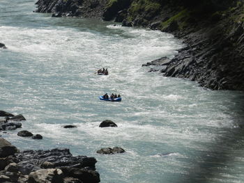 Distant view of people river rafting