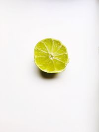 Close-up of lemon slice over white background