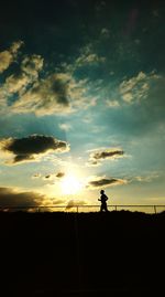 Silhouette of people at sunset