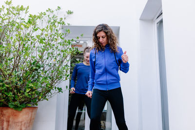 Woman standing against wall