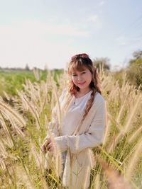 Portrait of a smiling young woman on field