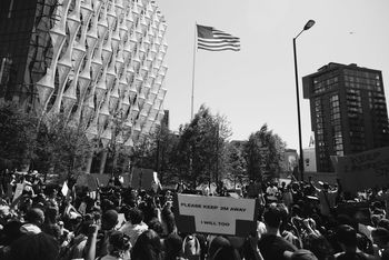 GROUP OF PEOPLE IN FRONT OF BUILDINGS