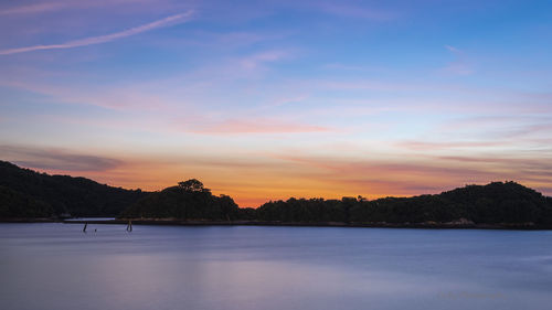 Scenic view of lake against sky during sunset