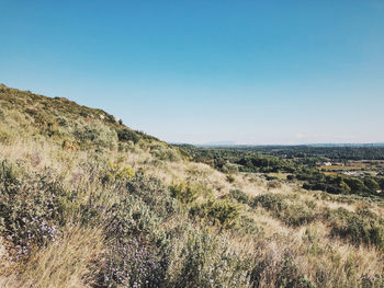 Scenic view of land against clear blue sky