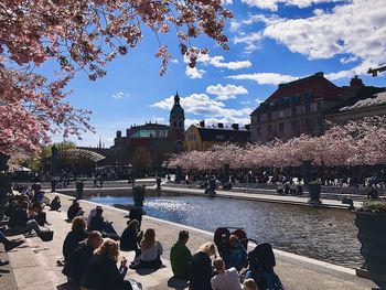 People in park by city against sky